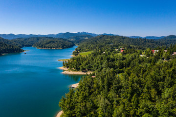 Aerial panoramic view of Lokvarsko Lake, beautiful mountain landscape on sunny summer day, Lokve, Gorski kotar, Croatia