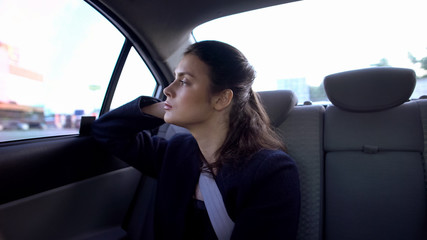 Exhausted lady in formal suit sitting on car backseat, burnout at work, troubles