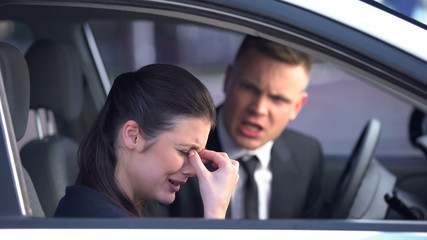 Unhappy woman crying after quarrel with boyfriend in car, relationship crisis