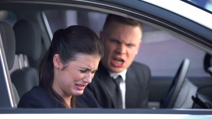 Boyfriend and girlfriend quarreling in car, lady crying, relationship crisis