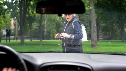 Driving car stopping front of scared female pedestrian, human factor, accident