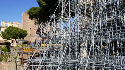 Close-up of metal industrial construction in the city centre. Structure of steel for building and renewing. High metal shapes, iron support elements in industry