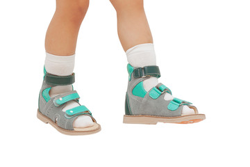 Orthopedic shoes on the feet of a child isolated on white background