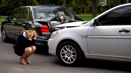 Frustrated woman covering head, car accident despair, driver suffering stress