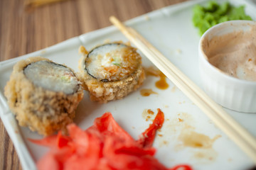 Empty dirty plate of sushi on table in cafe