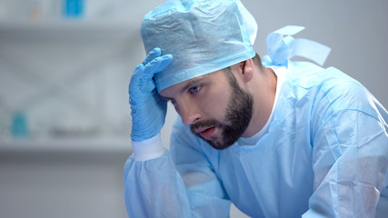 Shocked surgeon thinking about last unsuccessful operation, responsible work