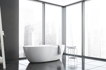 Panoramic gray bathroom corner with tub