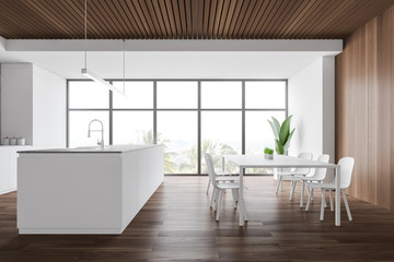 White and wooden kitchen with table and island