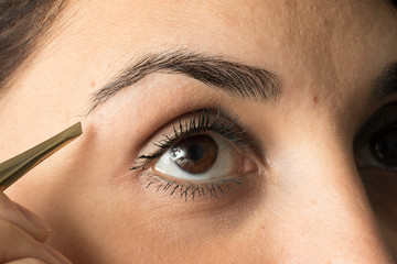 Young woman eyebrow correction close up