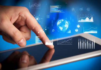 Hand holding tablet with global business concept