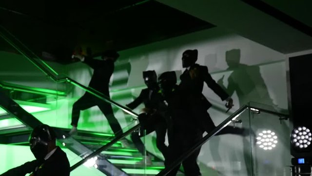 Masked people dance weird dance.