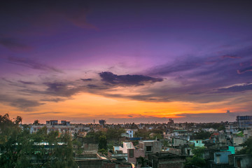 Cityscape from rooftop a colorful sunset
