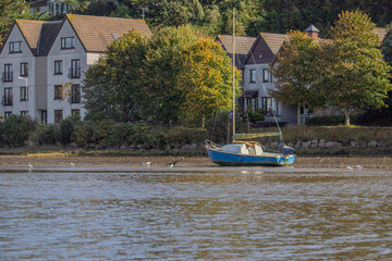 A small boat stranded on the mud