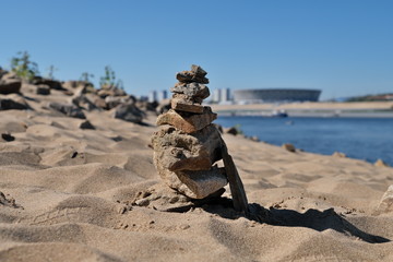 Cairn on the sandy bank of the river.