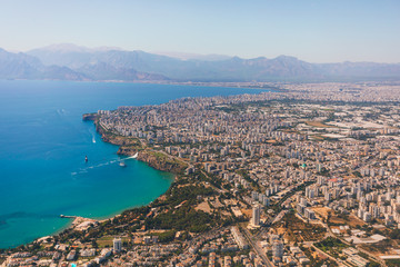 Window view of an airplane on the coast of Antalya with beautiful Taurus Mountains on the horizon, Turkey