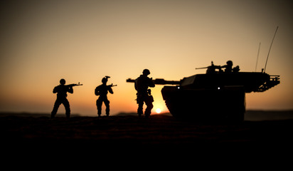 Fototapeta na wymiar War Concept. Armored vehicle silhouette fighting scene on war fog sky background. American tank at sunset.
