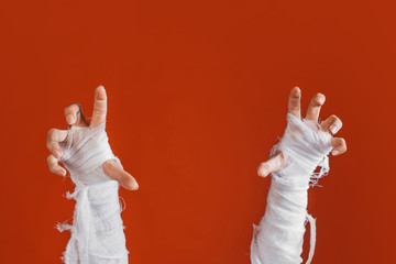 Halloween, costume image. The mummy's hand in bandages making gestures