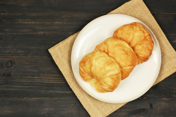 top view croissants on wooden background