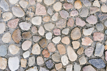 Stone paving on the sidewalk or road in the city, a background of stones and cement