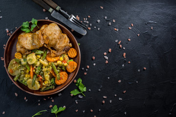 Fried chicken fillet with vegetables.