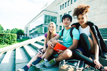 Fototapeta na wymiar cute group of teenages at the building of university with books huggings, diversity nations real students lifestyle
