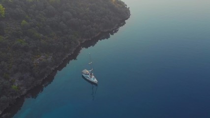 Sailing regatta, boat trip, top view. White yacht in the blue sea