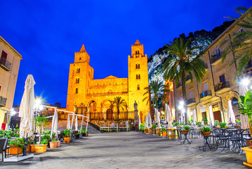 Fototapeta na wymiar Cefalu, Sicily, Italy: Night view of the town square with The Cathedral or Basilica of Cefalu, a Roman Catholic church built in the Norman style