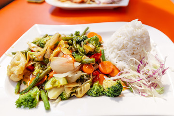 Fried vegetables with rice, Asian food on a plate