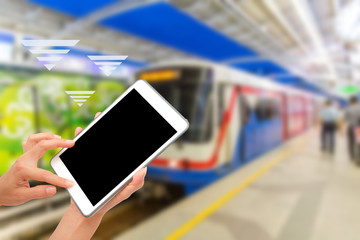 Hand using tablet PC on MRT train background