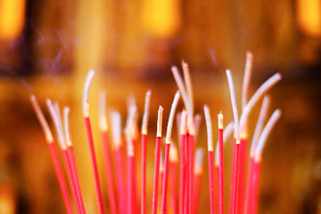 Burned incense sticks with blurry background
