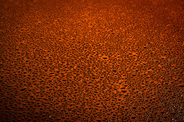 Water drops on dark surface.