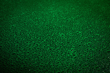 Water drops on dark surface.