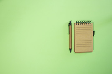 Brown notebook in green background