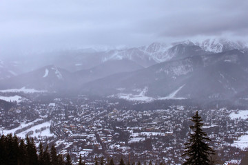 View of Zakopane and Tatra Mountains from Gubalowka in the winter in snowing weather. Zakopane is the Winter Capital of Poland