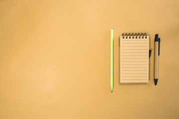 Brown notebook in orange background