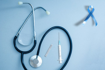 Blue ribbon and stethoscope on white background. Prostate cancer awareness. Copy space. Men...