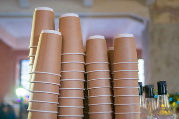 Stacks upside down empty takeaway disposable coffee cardboard cups at cafe
