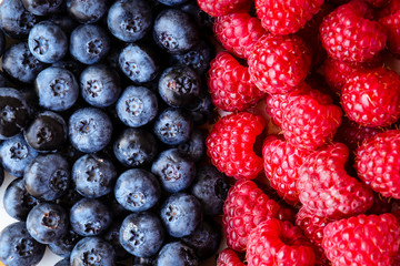 Red and blue. Raspberry and blueberry. Background of the raspberry and blueberry. Summer concept.