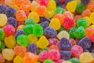 Background - assortment of delicious marmalade jelly candies for sale on counter of shop, grocery, market, cafe. Dessert, copy space, sweet food, pattern and confectionery concept