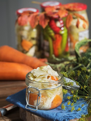 Jar with fermented vegetables. Fermented, canned vegetarian food, concepts. Cabbage, dill, carrots, green peppers. The concept of canned food. Close-up. Autumn. Vertical frame.