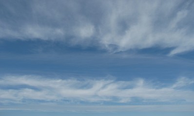 Obraz premium white clouds like a spider web on blue sky