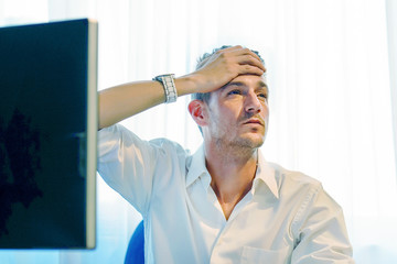 Close-up office worker man suffering from headache migraine pain. Health problem, stress and depression. Male holds head with hand. Concept of health.        