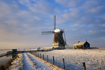 Windmill in the warm sunlight of a winter sunrise