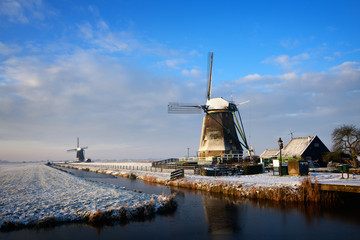 Windmills in a winter landscape in the Netherlands