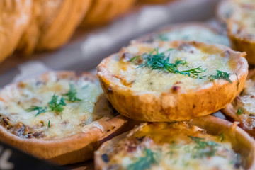 Assortment of delicious freshly baked tart pies with cheese, meat, mushroom and dill for sale on counter of shop, grocery, market, cafe or bakery. Food, gastronomy and pastry concept