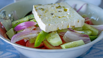 Traditional Greek salad with one big slice cheese