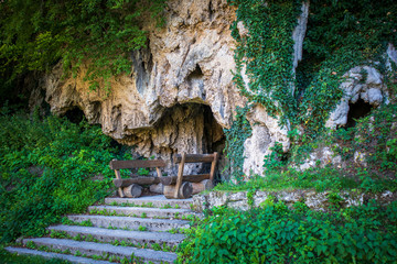 Benches and table in front of cave in Martin Brod in Bosnia and Herzegovina