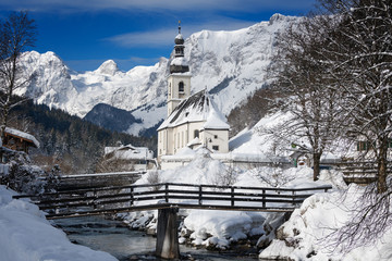 Church with Alps mountains in the snow in winter