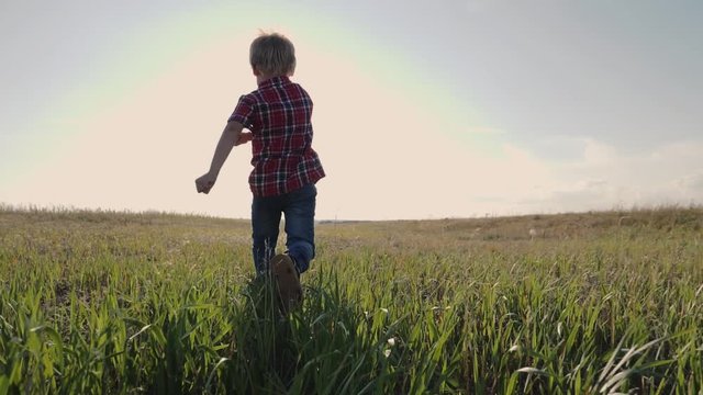 happy family little boy a runs concept slow motion video. happy child girl with sunset nature outdoors running on meadow in summer in nature. lifestyle happy carefree childhood concept