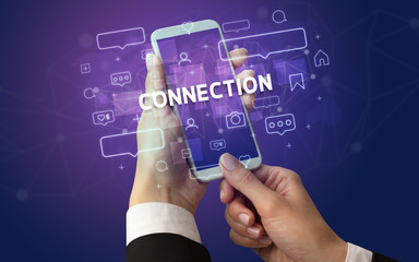 Female hand typing on smartphone with CONNECTION inscription, social media concept